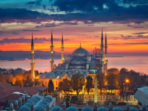 The historic Blue Mosque with its six minarets illuminated during a breathtaking sunrise in Istanbul, Turkey.