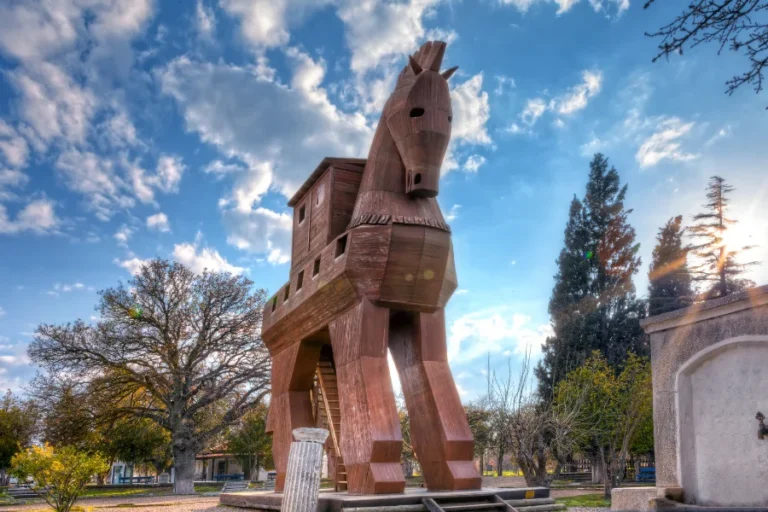 The iconic wooden replica of the Trojan Horse standing at the archaeological ruins of ancient Troy in Turkey.
