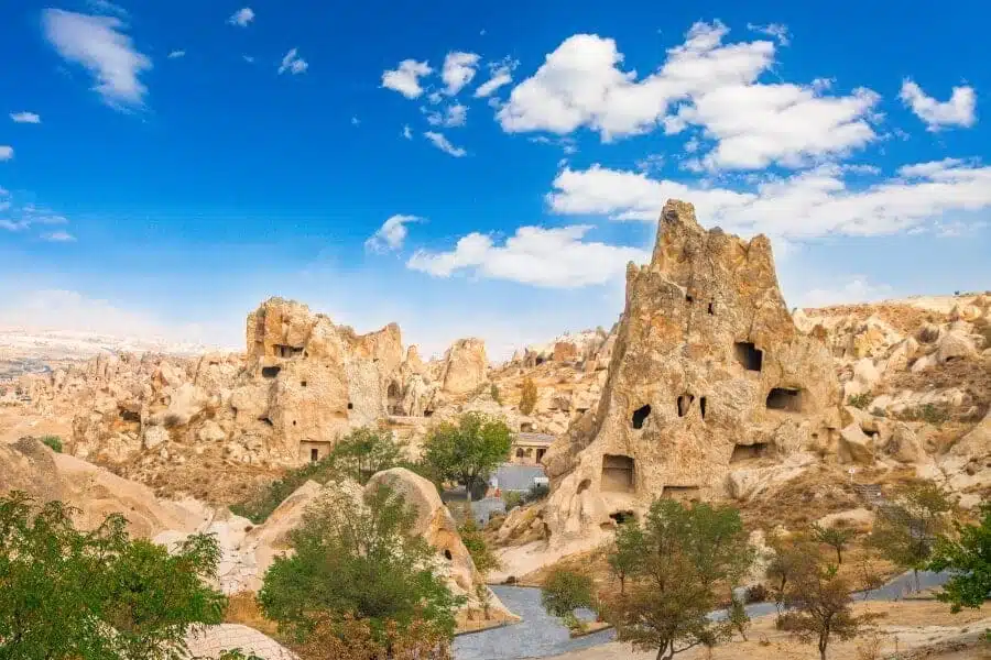 A scenic view of Goreme Open Air Museum featuring ancient cave churches and frescoes in a rocky landscape.